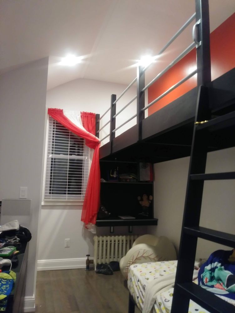 A bedroom with a bunk bed and a ladder