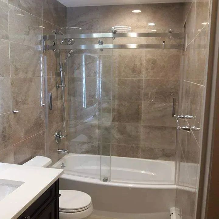A bathroom with a tub, toilet, sink and shower