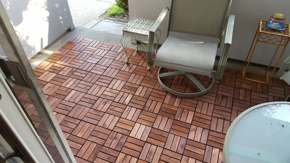 A chair is sitting on a wooden floor on a patio