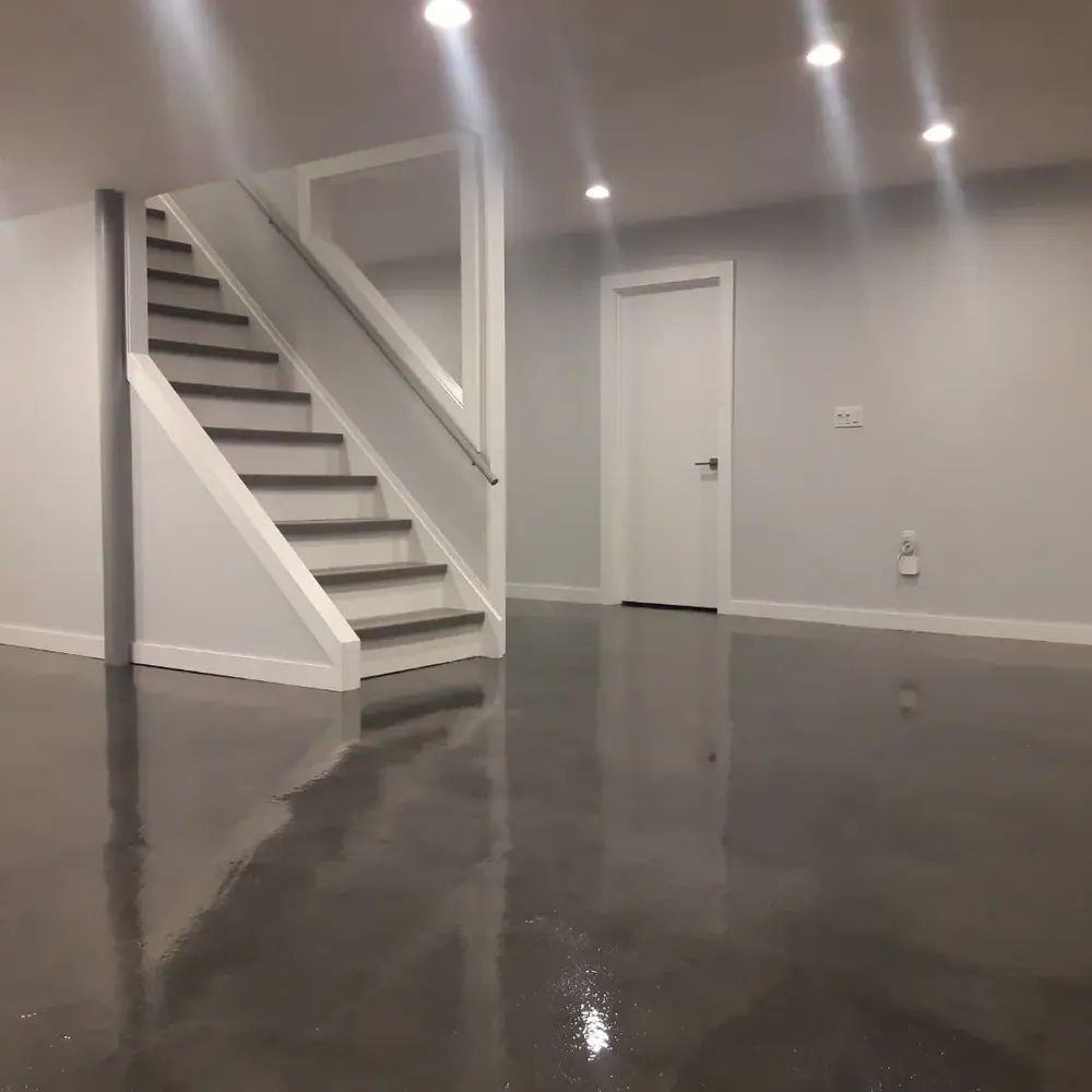 An empty basement with stairs and a door