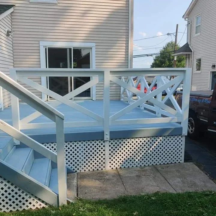 A house with a blue deck and white railing
