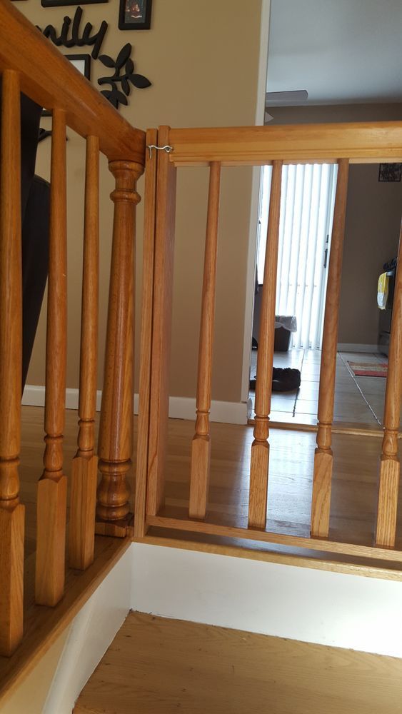 A wooden railing on a set of stairs in a house