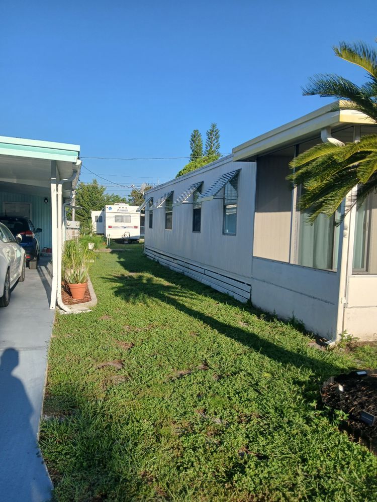 A couple of mobile homes are parked next to each other in a yard