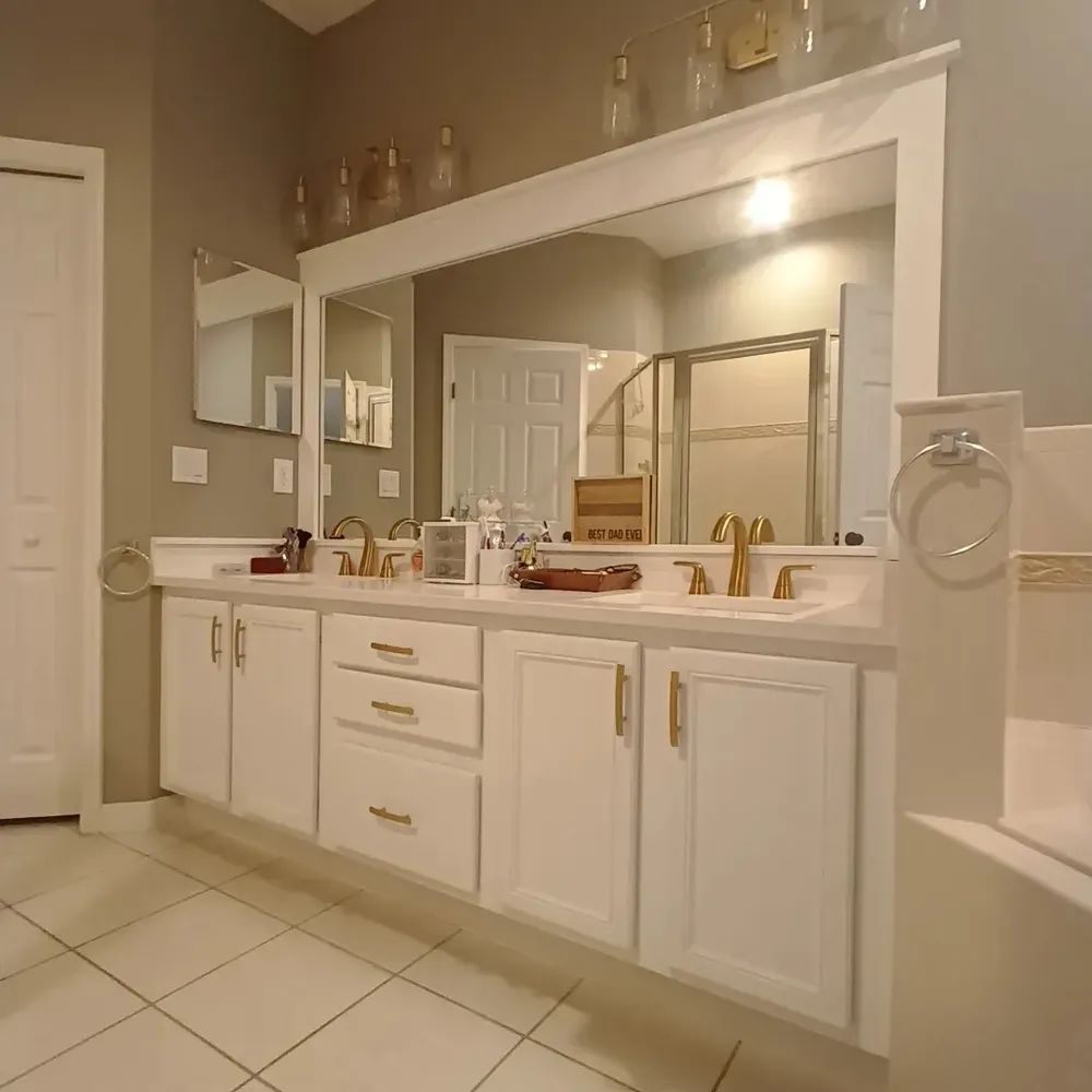 A bathroom with two sinks and a large mirror