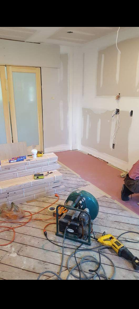 A room that is being remodeled with a lot of tools on the floor