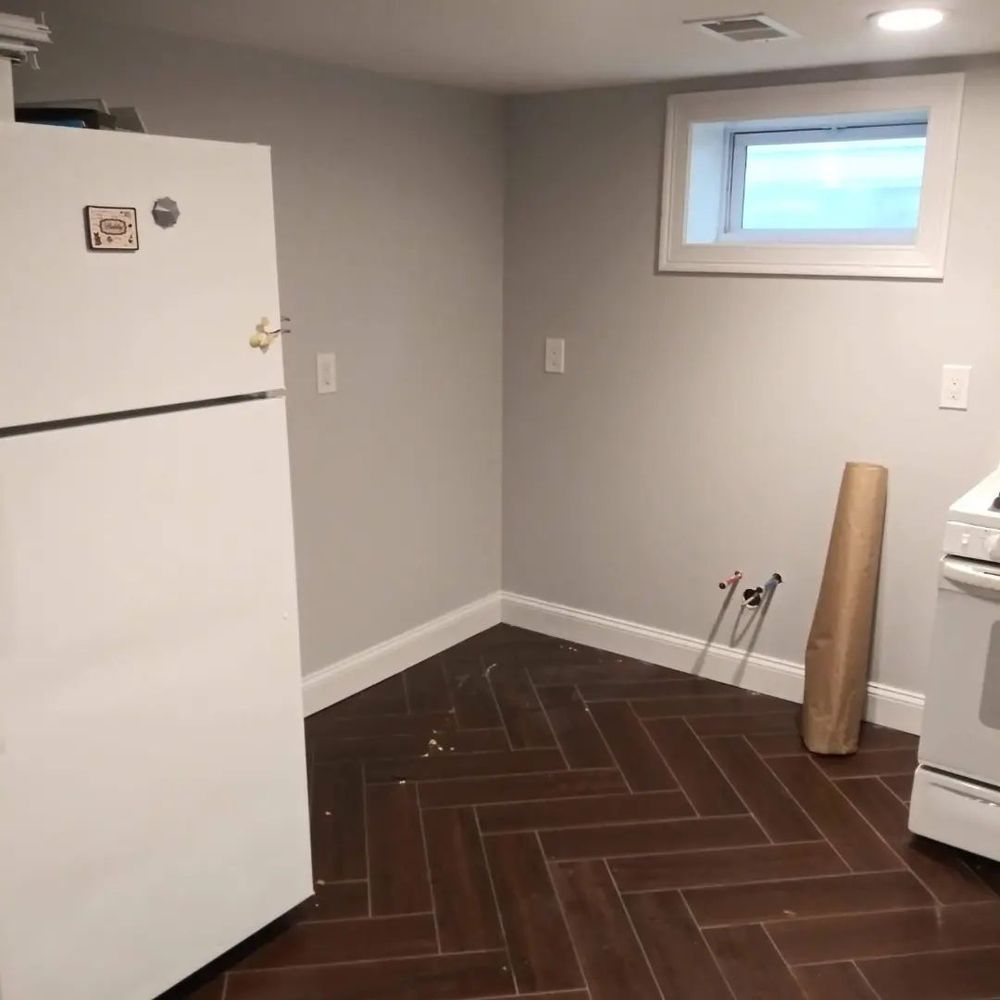 A kitchen with a white refrigerator and a stove