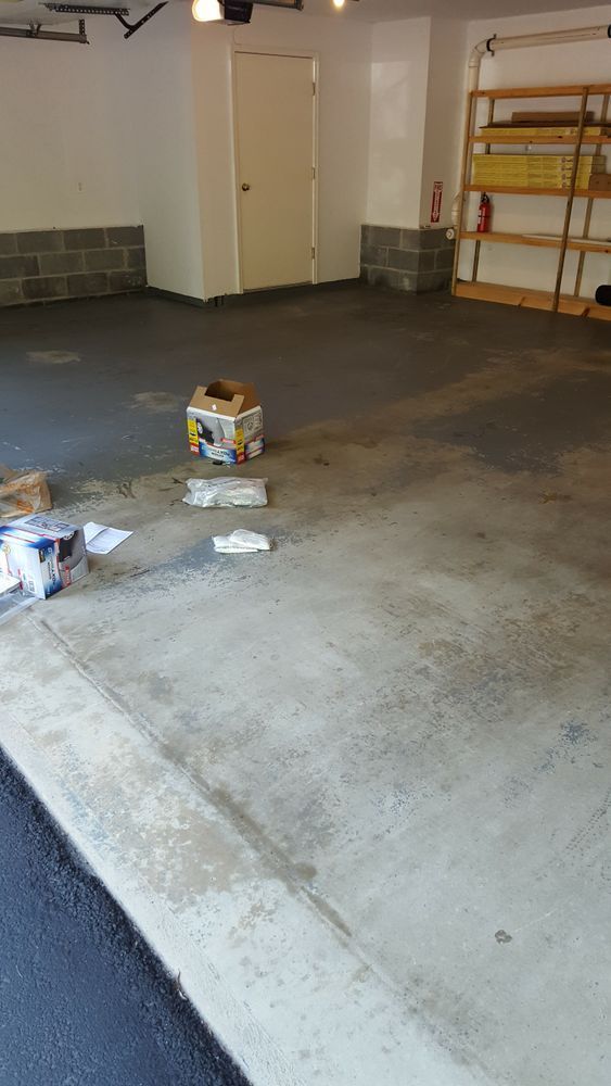An empty garage with a box on the floor.