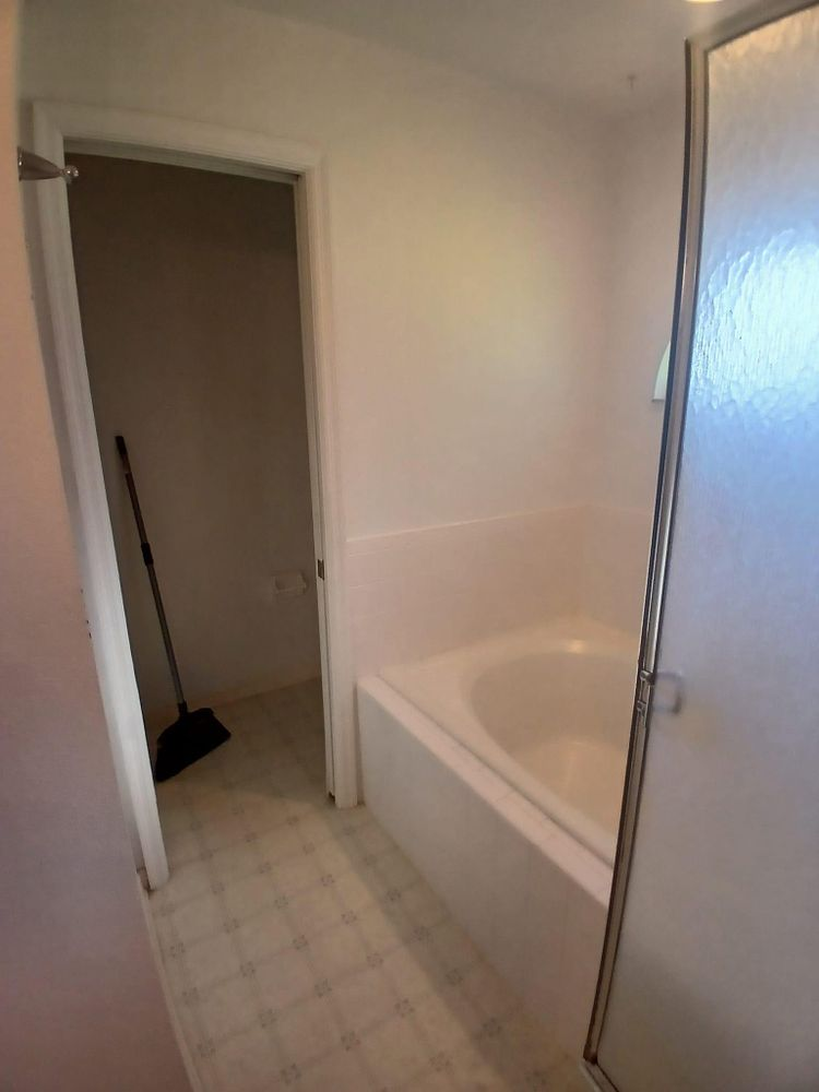 A bathroom with a bathtub and a walk in shower