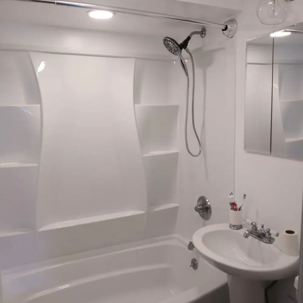 A bathroom with a bathtub sink and shower head