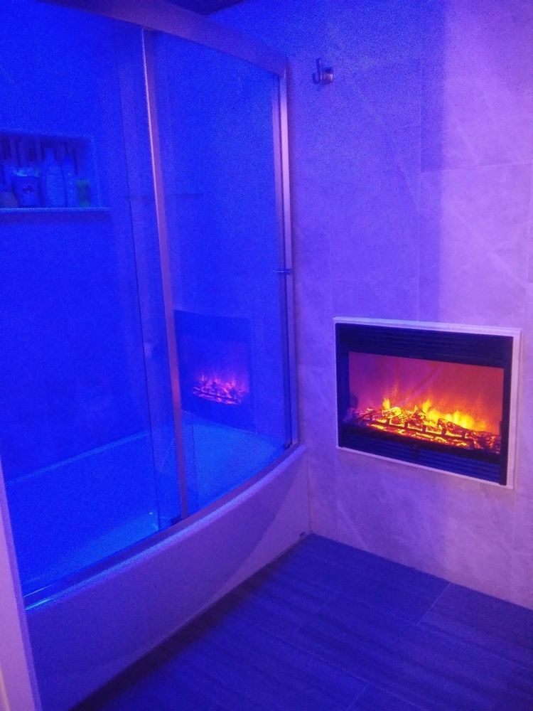 A bathroom with a fireplace and a bathtub