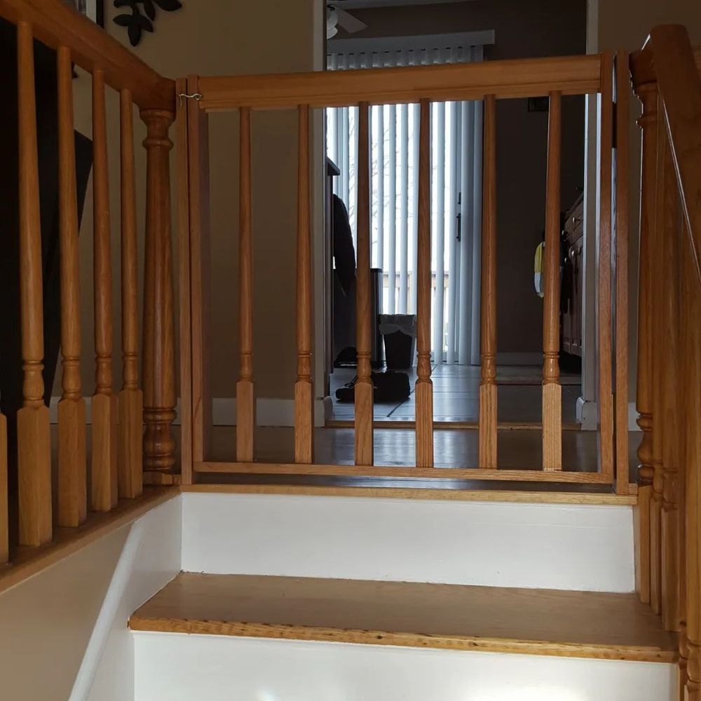 A wooden staircase with white steps and a wooden railing