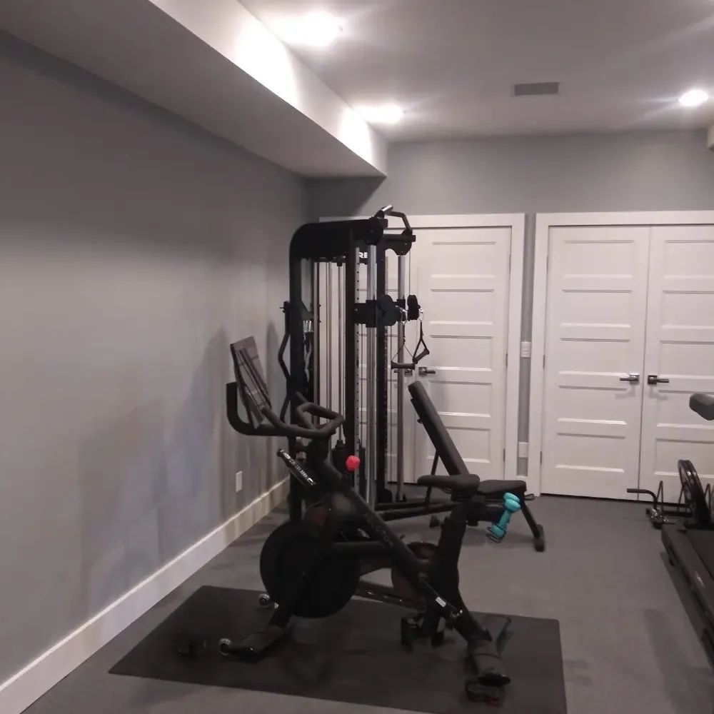 A gym with a treadmill and a bicycle