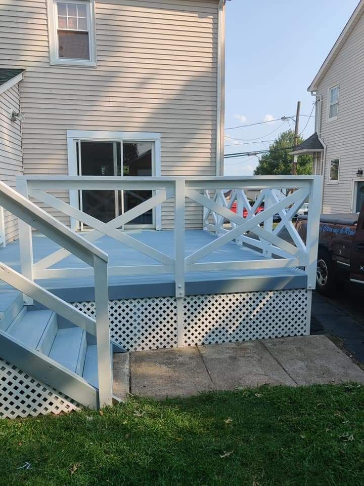 A white house with a blue deck and stairs