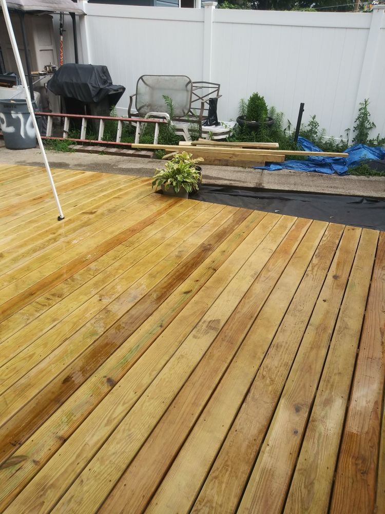 A wooden deck is being built in a backyard