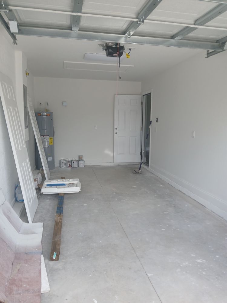 An empty garage with white walls and a white door