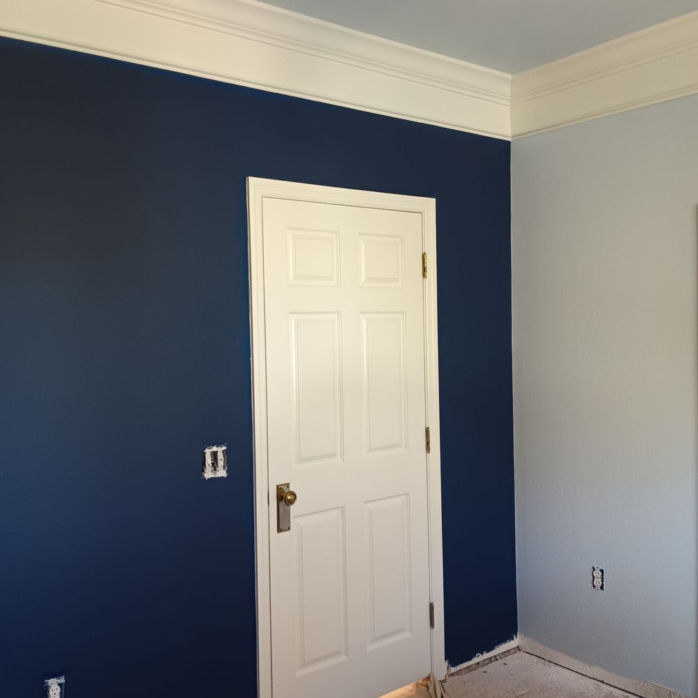 A room with blue walls and a white door