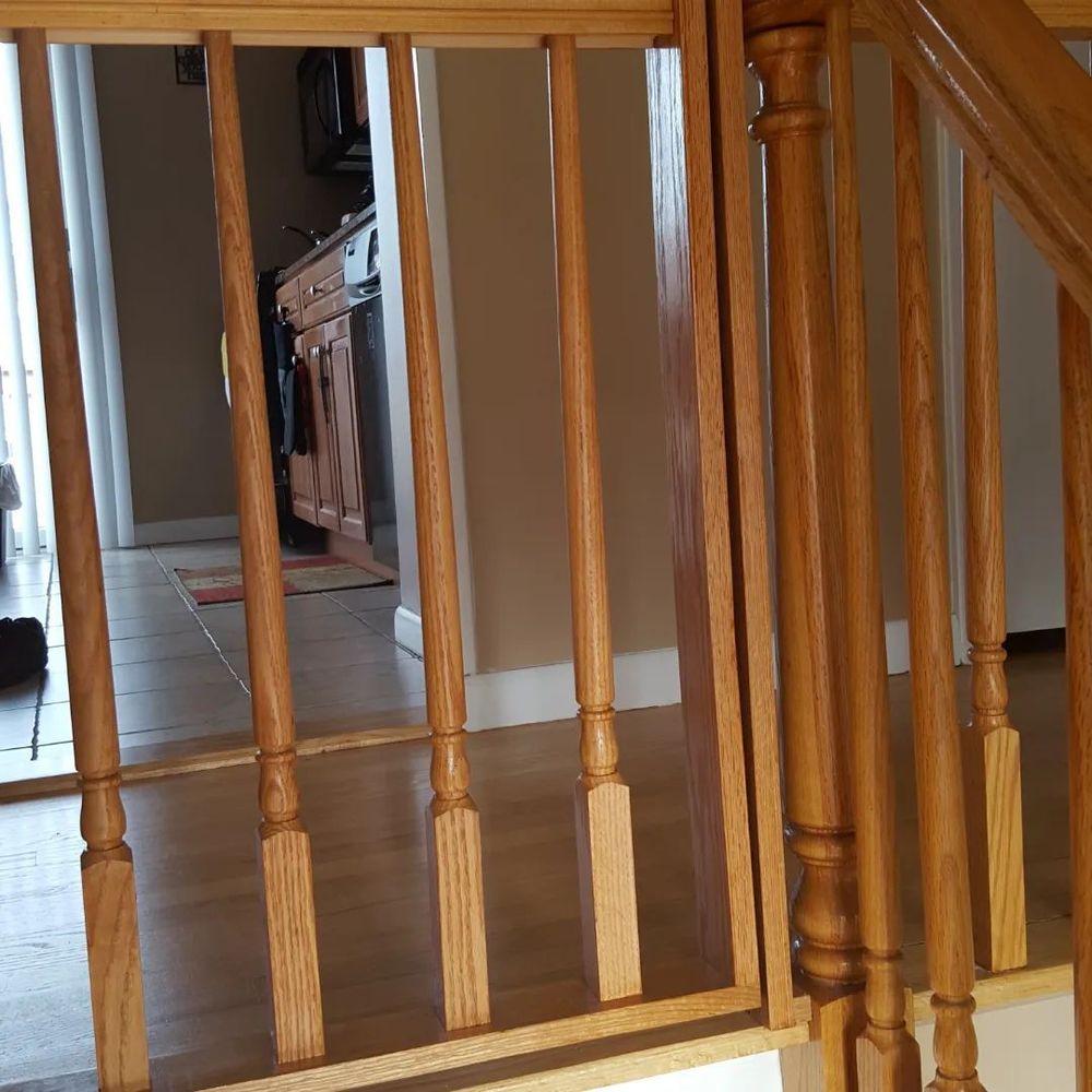 A wooden railing with a kitchen