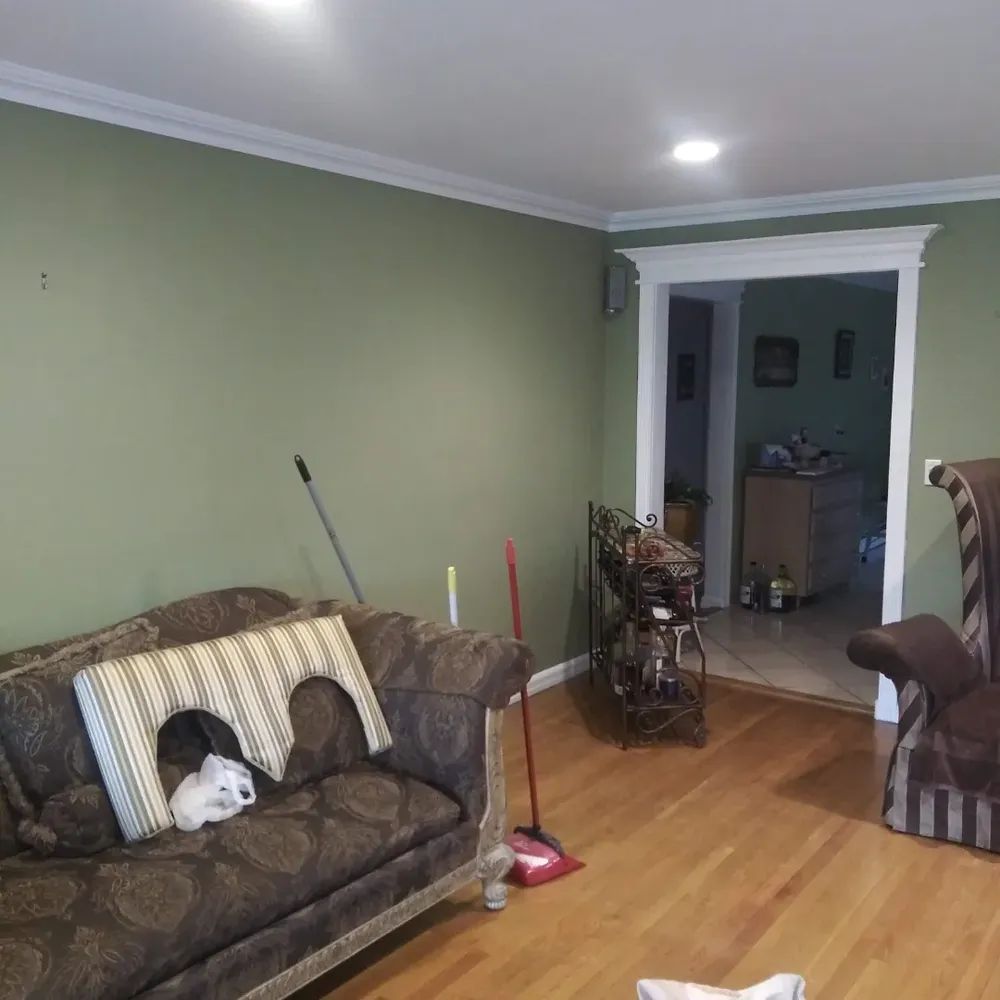 A living room with a couch a chair and a broom