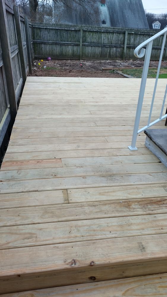 A wooden deck with stairs and a fence