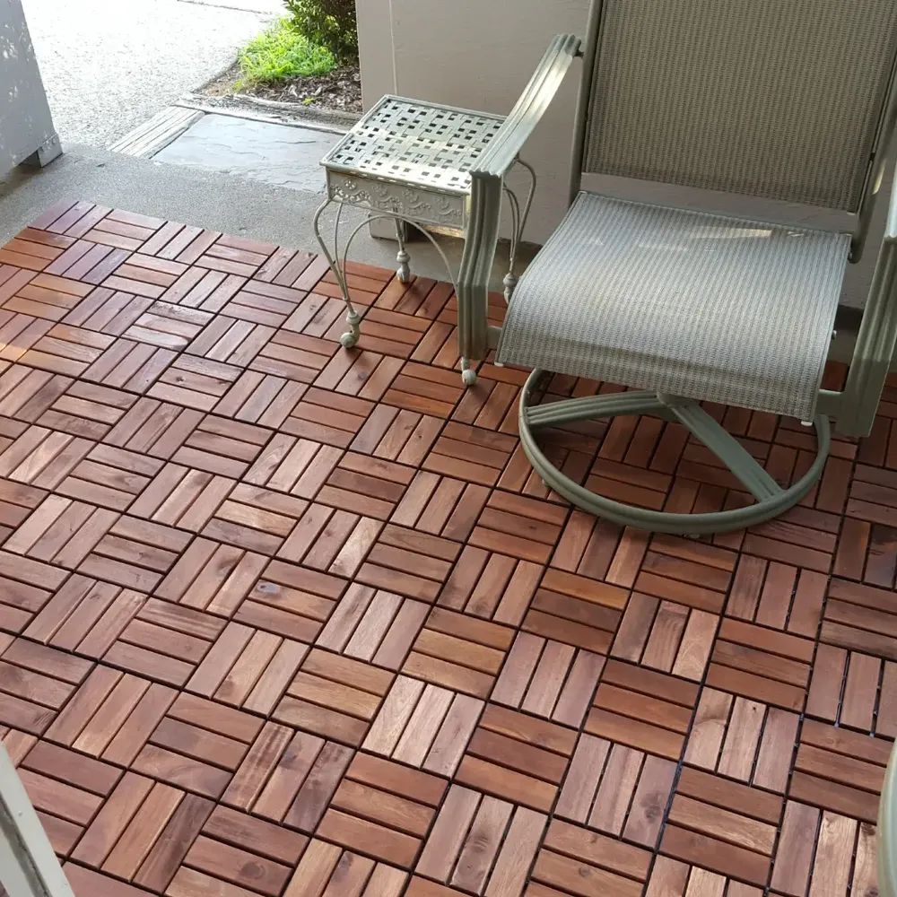 A wooden floor with a chair and a table on it