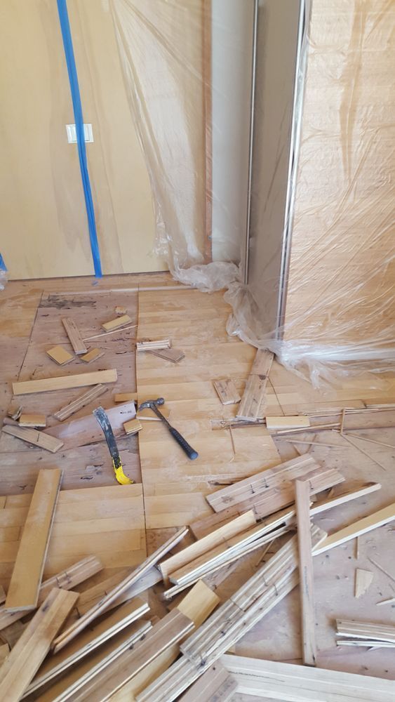 A pile of wood is laying on the floor in a room