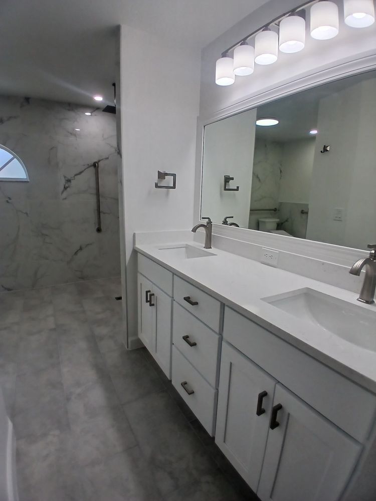 A bathroom with two sinks and a large mirror