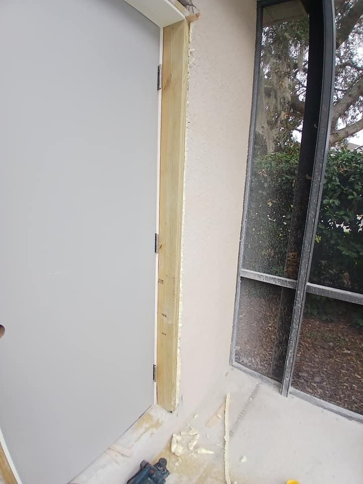 A door is being built into a wall next to a window