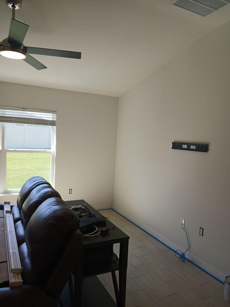 A living room with a ceiling fan and a couch