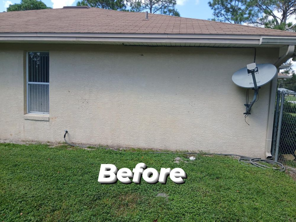A before picture of a house with a satellite dish on the side.