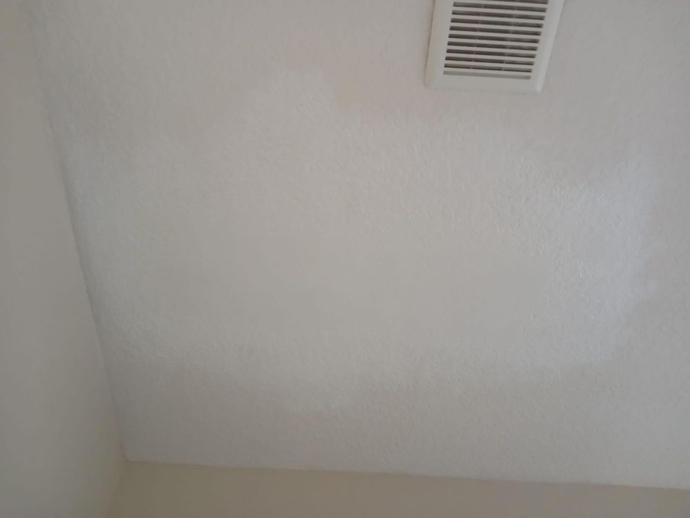 There is a vent on the ceiling of the room.