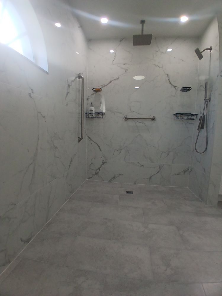 A bathroom with a walk in shower and a shower head