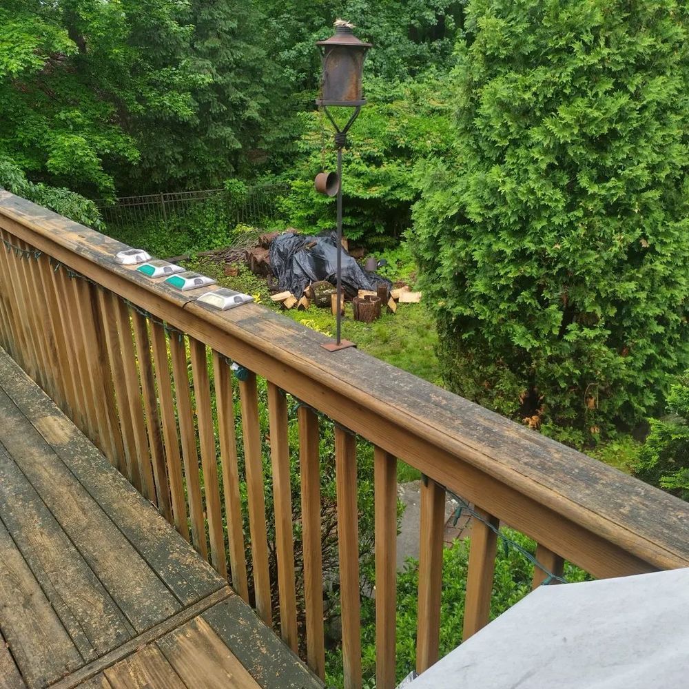 A wooden deck with a bird feeder on top of it