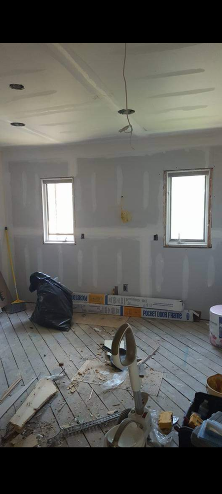 A room that is being remodeled with a lot of tools on the floor