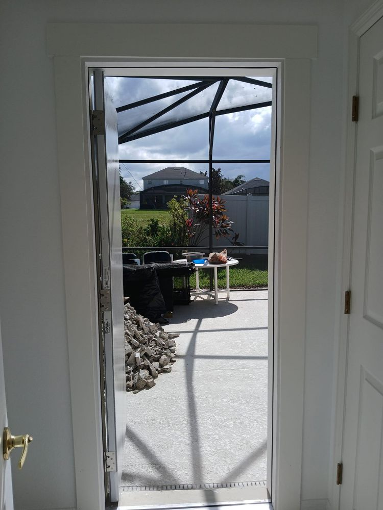 An open door leading to a screened in patio