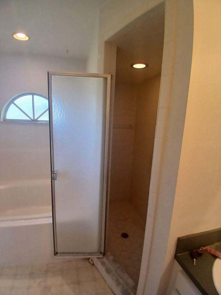 A bathroom with a bathtub and a walk in shower