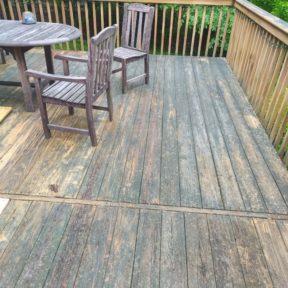 A wooden deck with a table and chairs on it