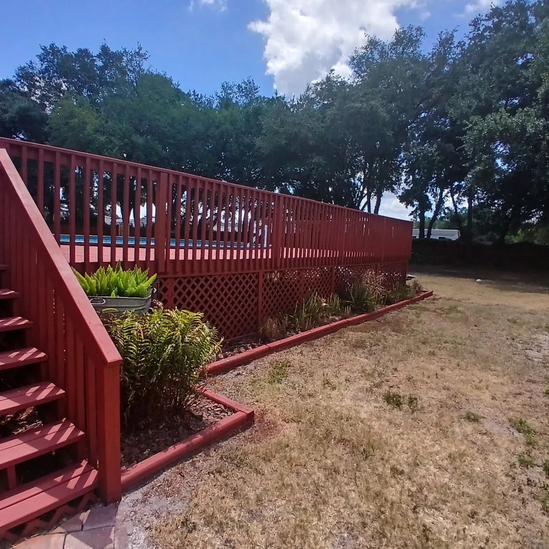 A red deck with stairs leading up to it
