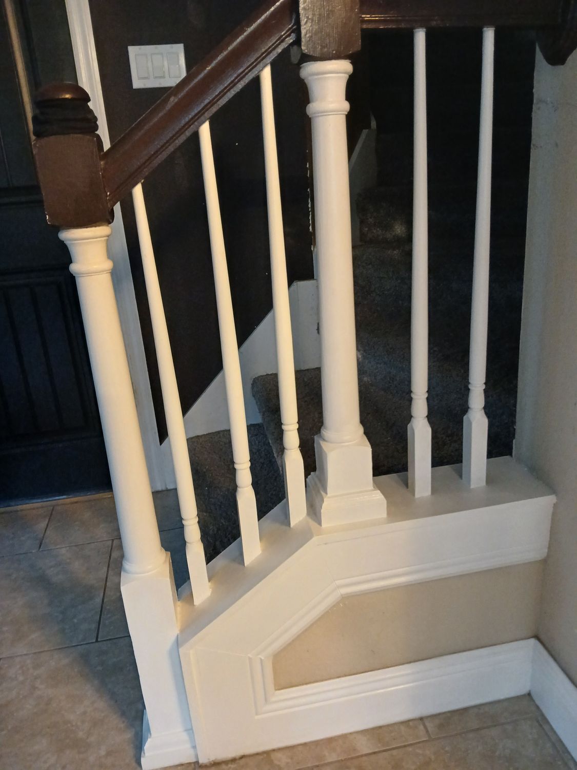 A staircase with white railings and a brown handrail