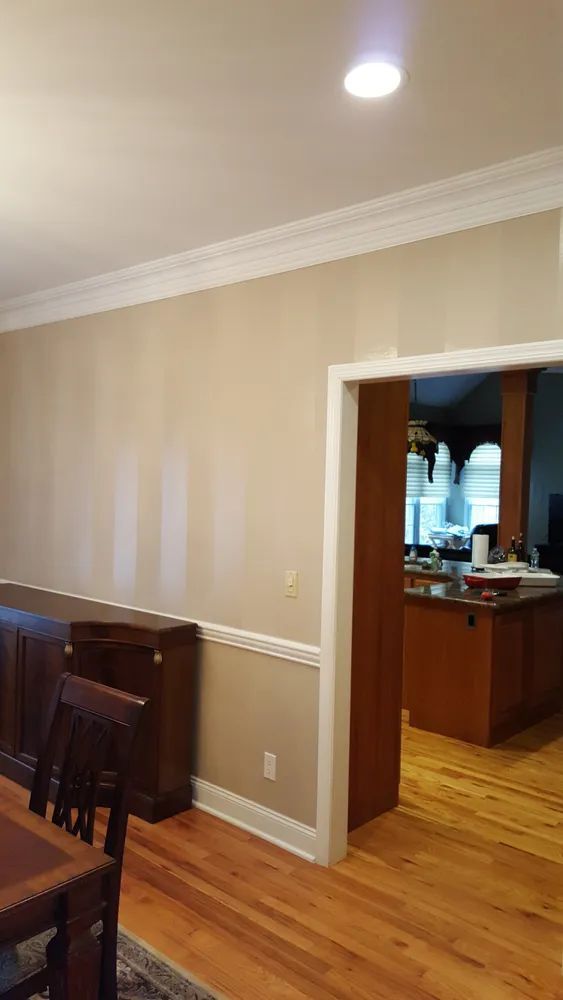 A dining room with a table and chairs and a kitchen