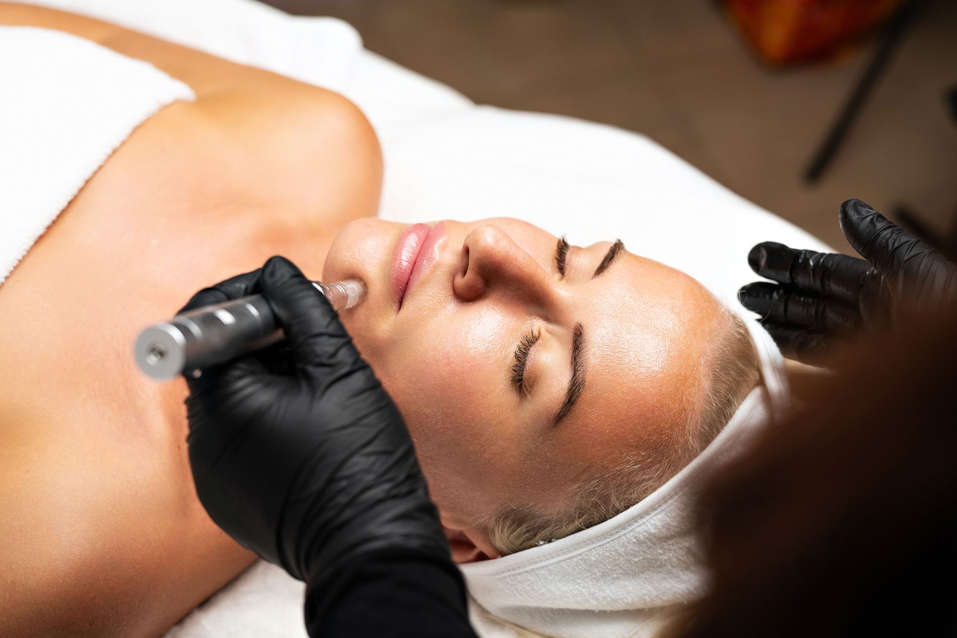 A woman is getting a facial treatment at a spa.