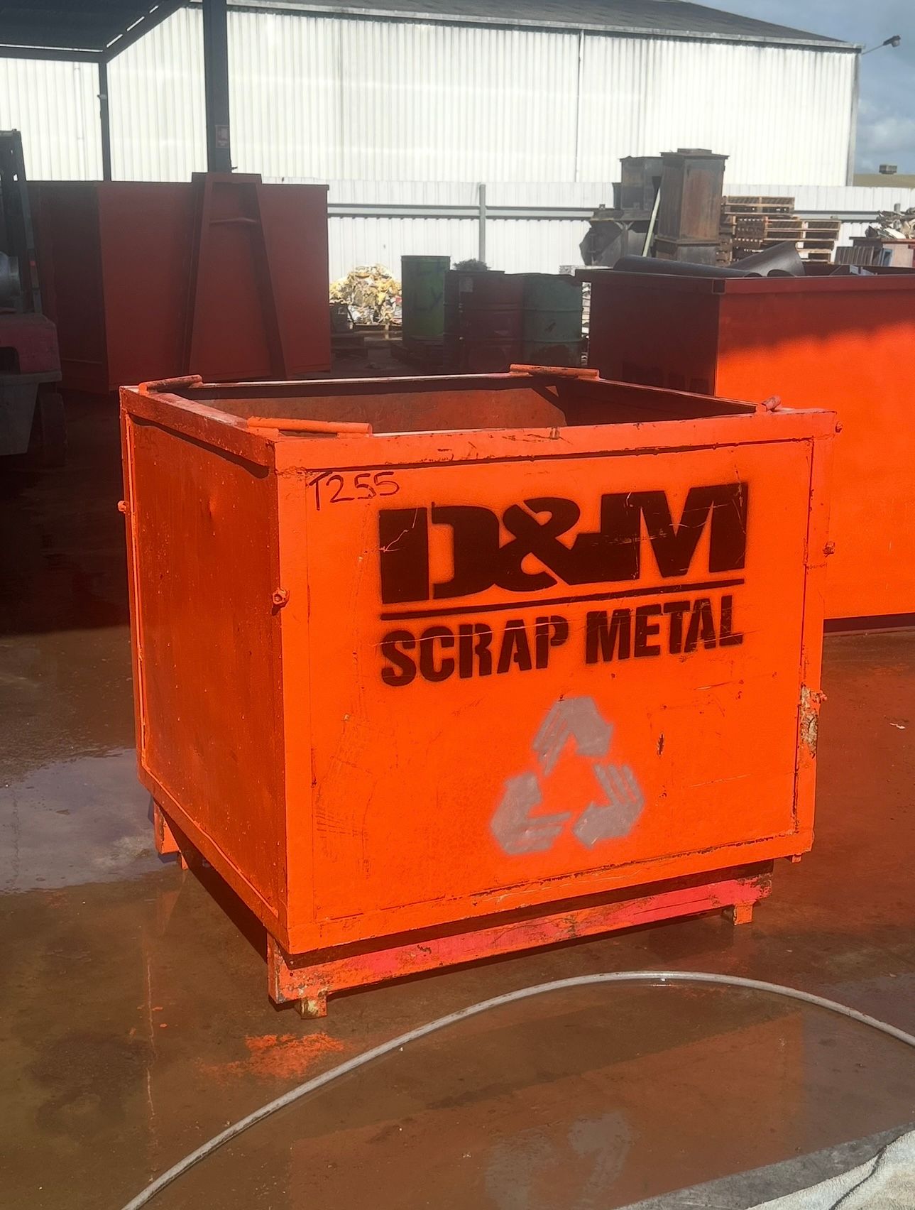 An orange metal scrap bin.