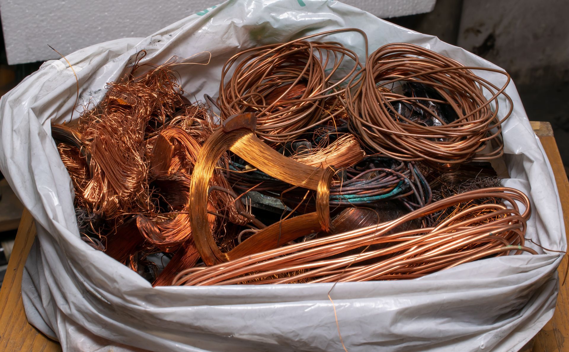 A bag of copper wire is sitting on a wooden table