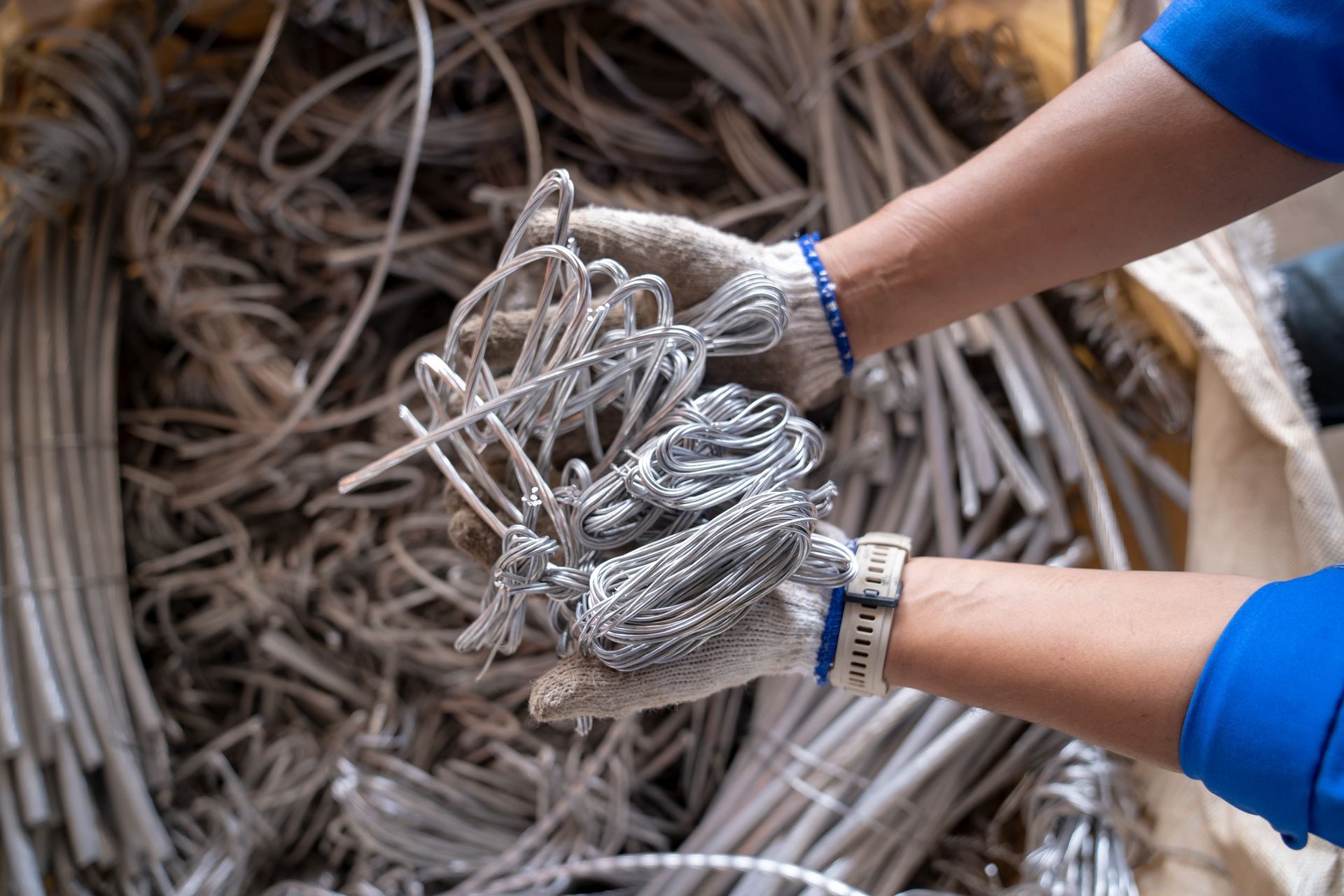 A person is holding a pile of wire in their hands.