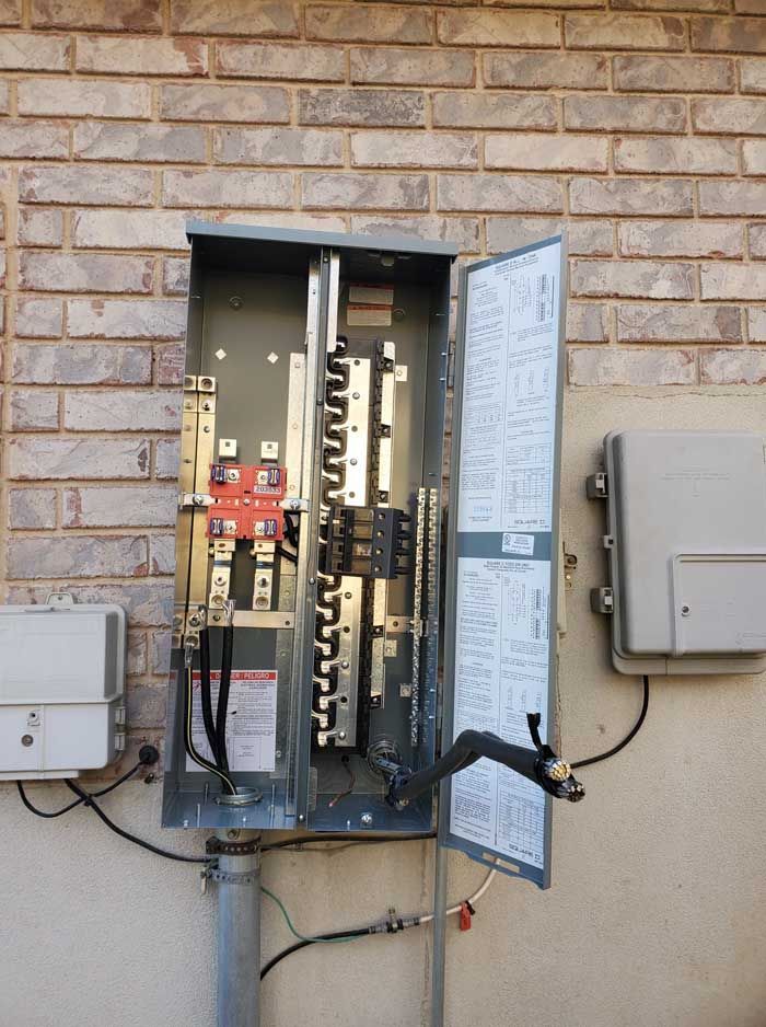 A brick wall with a electrical box on it