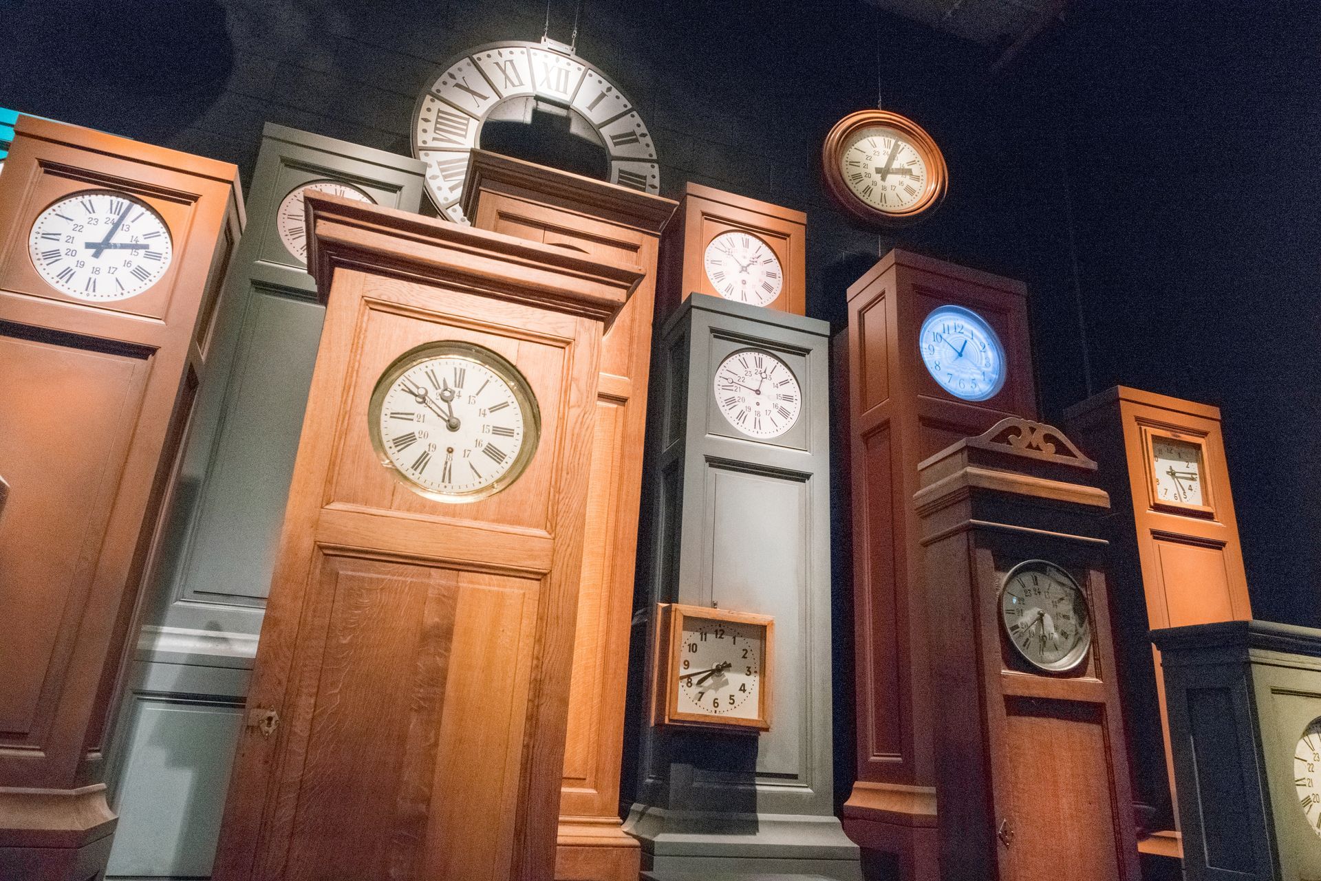 Display of wooden clocks of all sizes, showcasing grandfather clock repair craftsmanship. Display of wooden clocks of all sizes, showcasing grandfather clock repair craftsmanship.