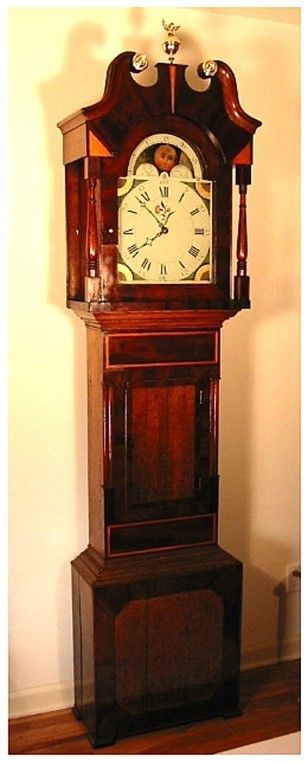 Grandfather clock restoration of an antique wooden-framed clock with timeless elegance and detail. Grandfather clock restoration of an antique wooden-framed clock with timeless elegance and detail.