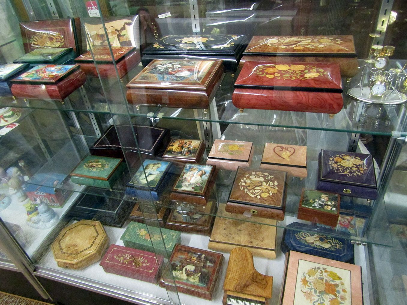 A glass display case filled with a variety of boxes