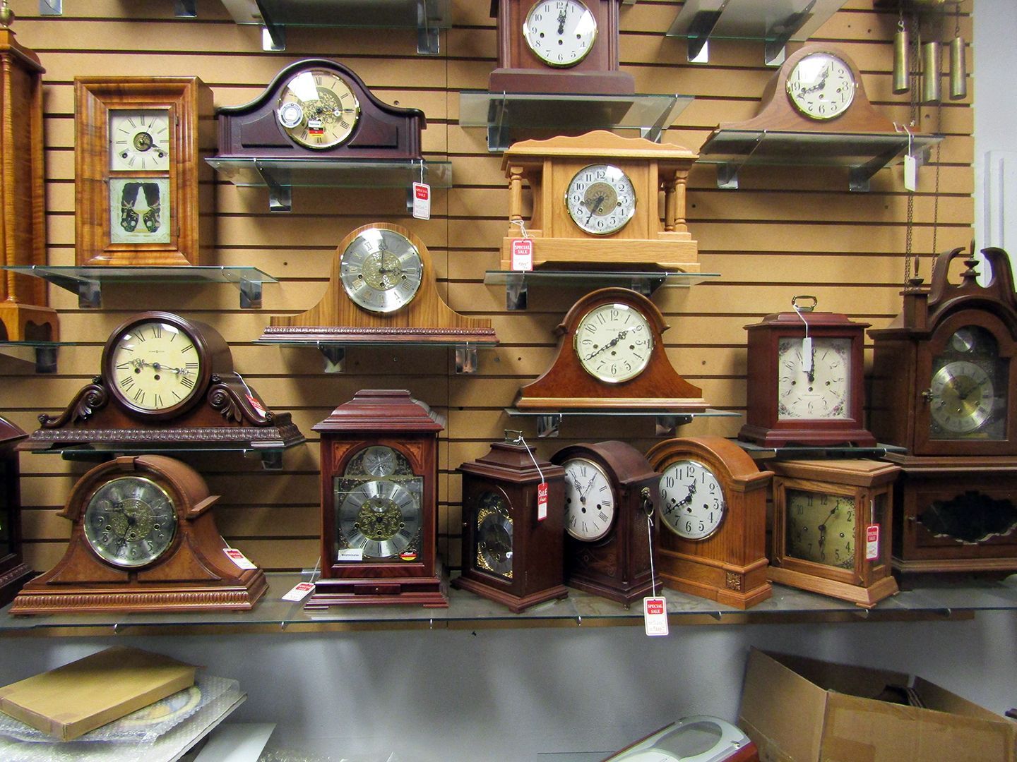 A Collection of Clocks Are Displayed on Shelves in A Store.