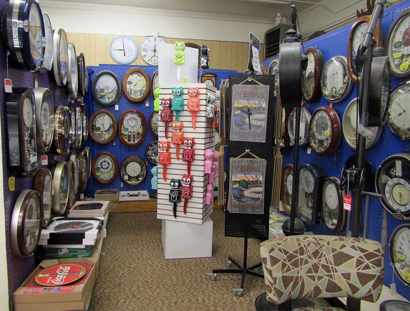 A store filled with lots of clocks and a chair