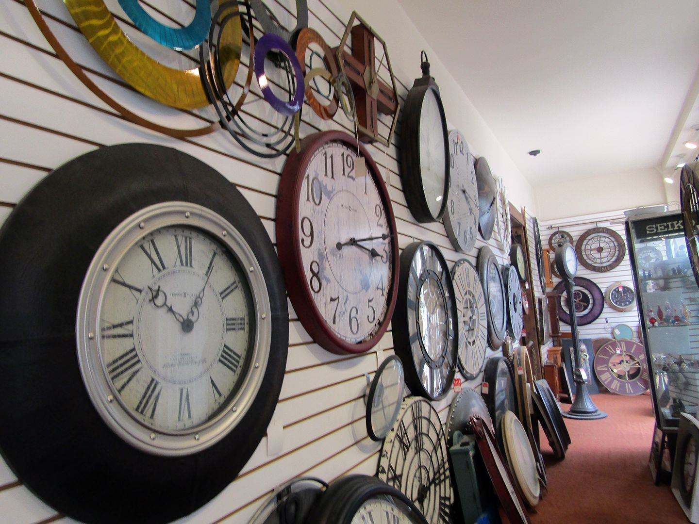 A Bunch of Clocks Are Hanging on A Wall in A Store.